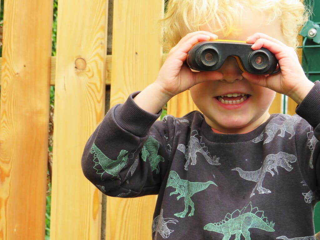 Nursery child with binoculars