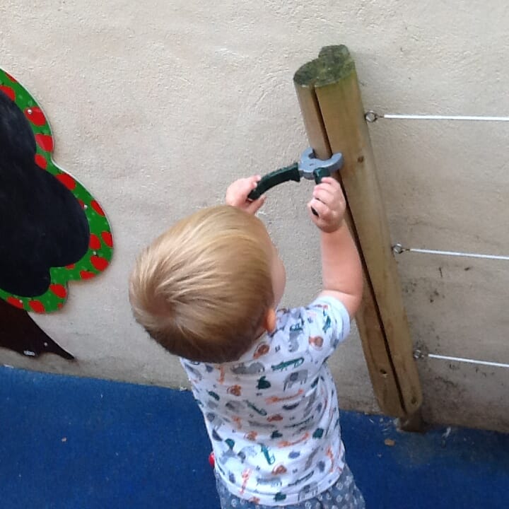 Child playing with tools at Iver nursery