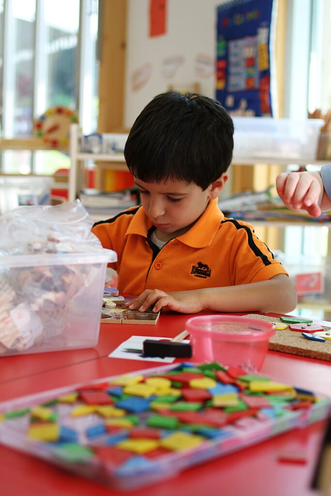 A child doing a puzzle at WASPS