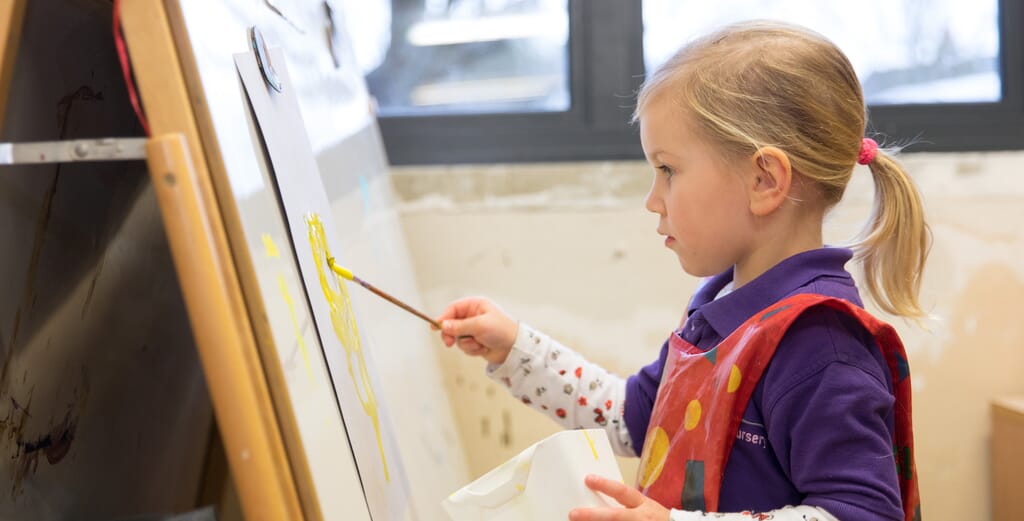 Child painting at nursery