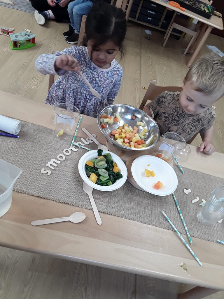 Nursery children making their own smoothies