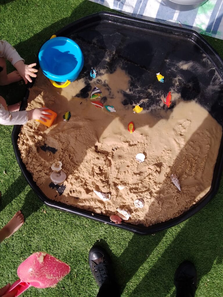 Nursery child playing with sand