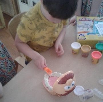 Nursery child playing with play-doh