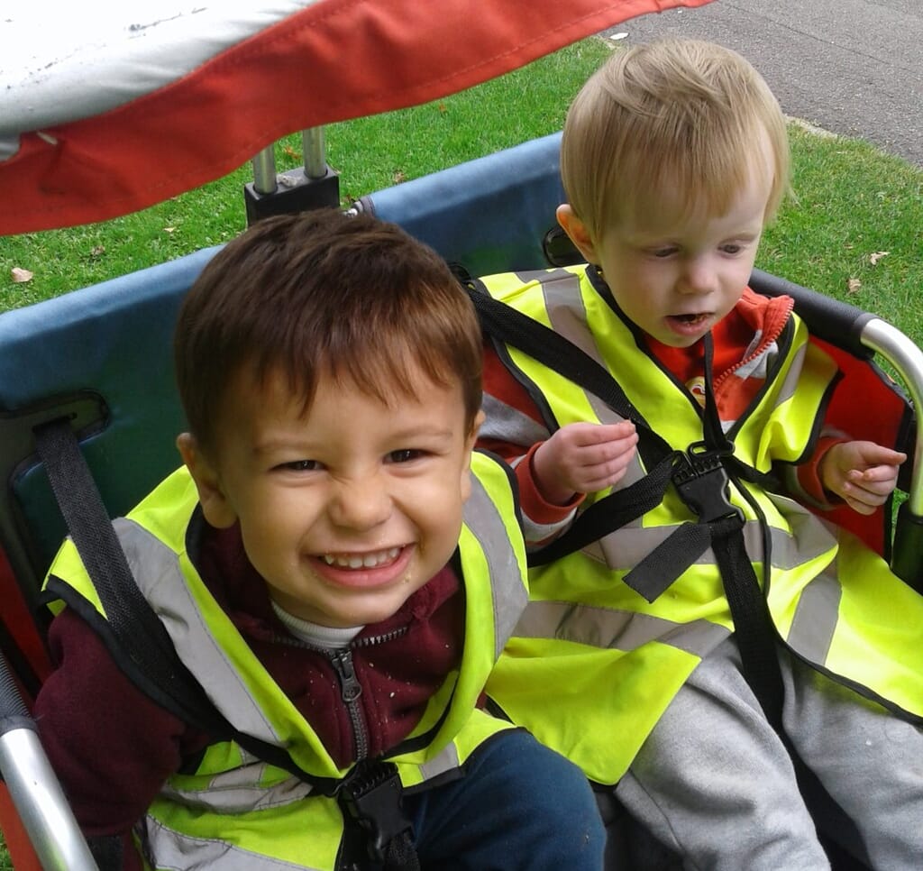 Nursery children in a buggy outdoors