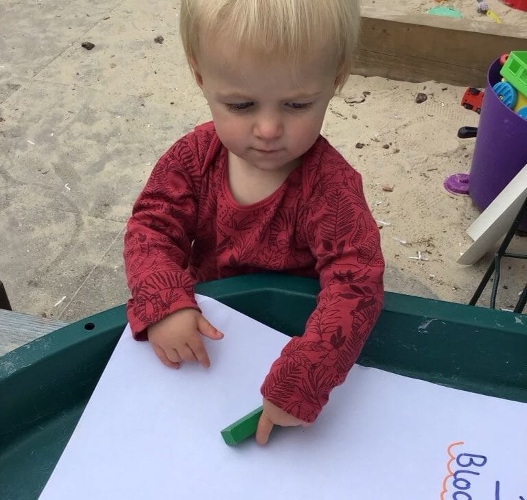Nursery child playing outdoors