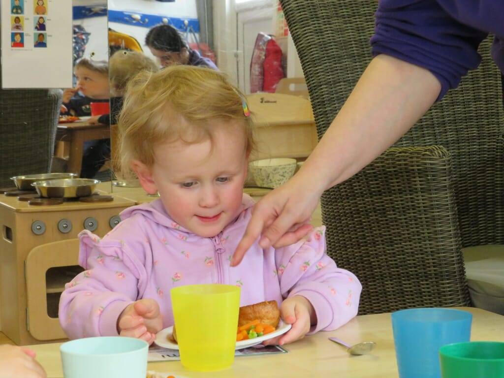 Nursery child eating lunch