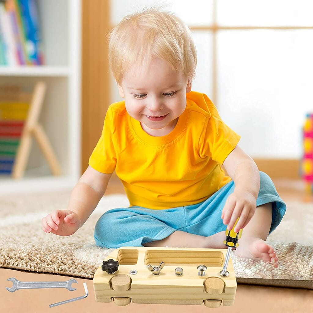 Nursery child building a car