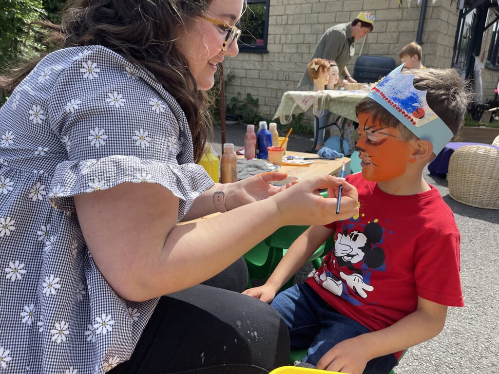 Nursery child getting his face painted