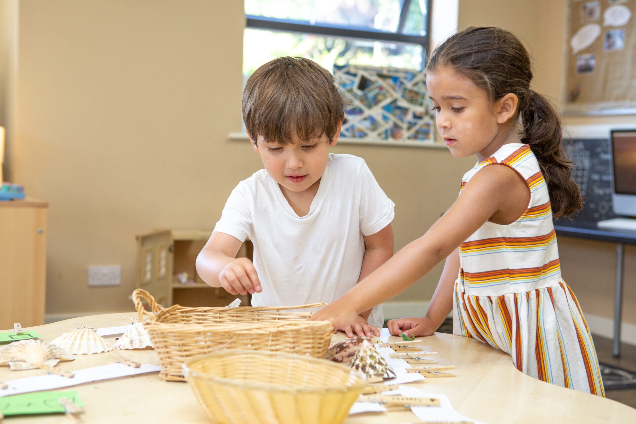 Children at the nursery playing with shellfish