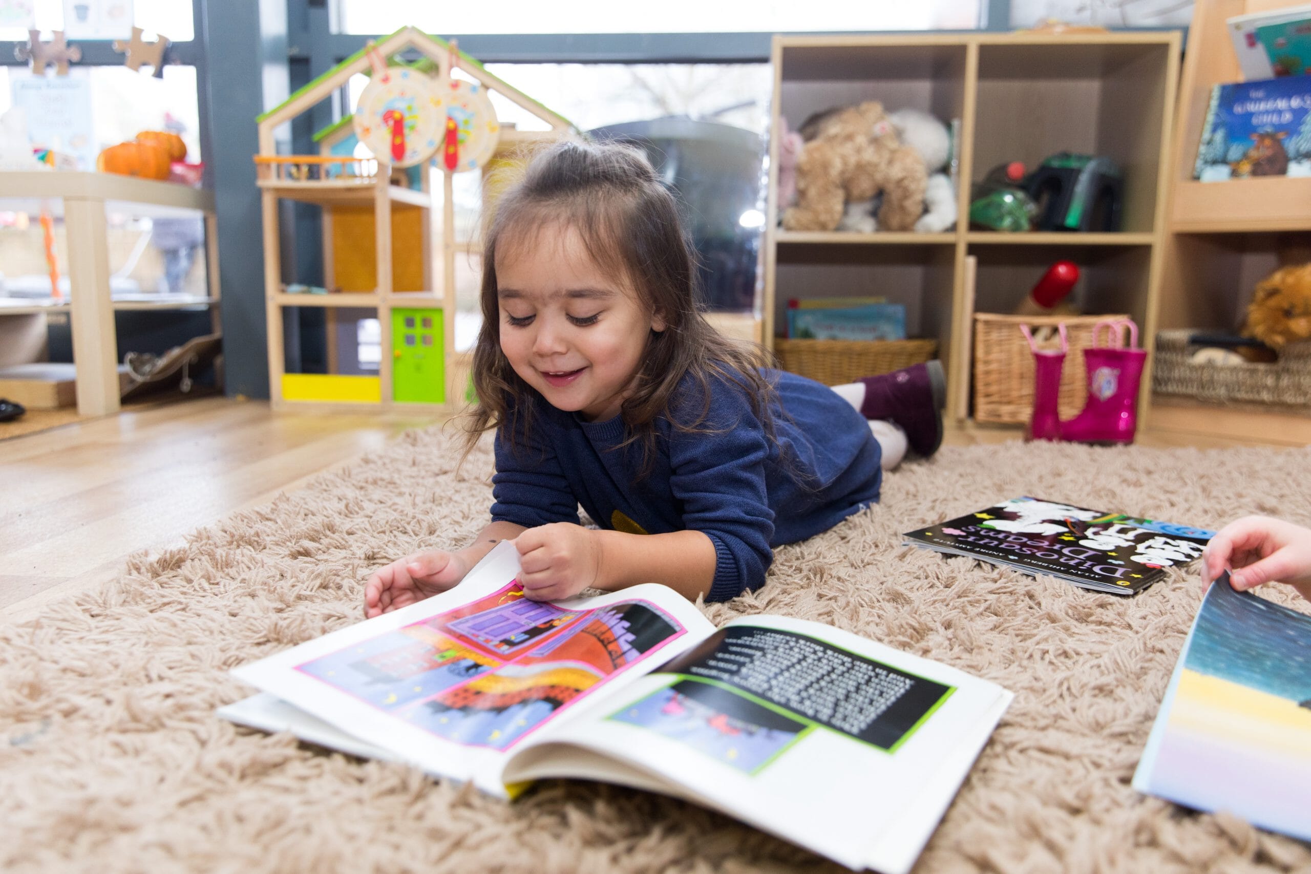 Child reading book on the floor