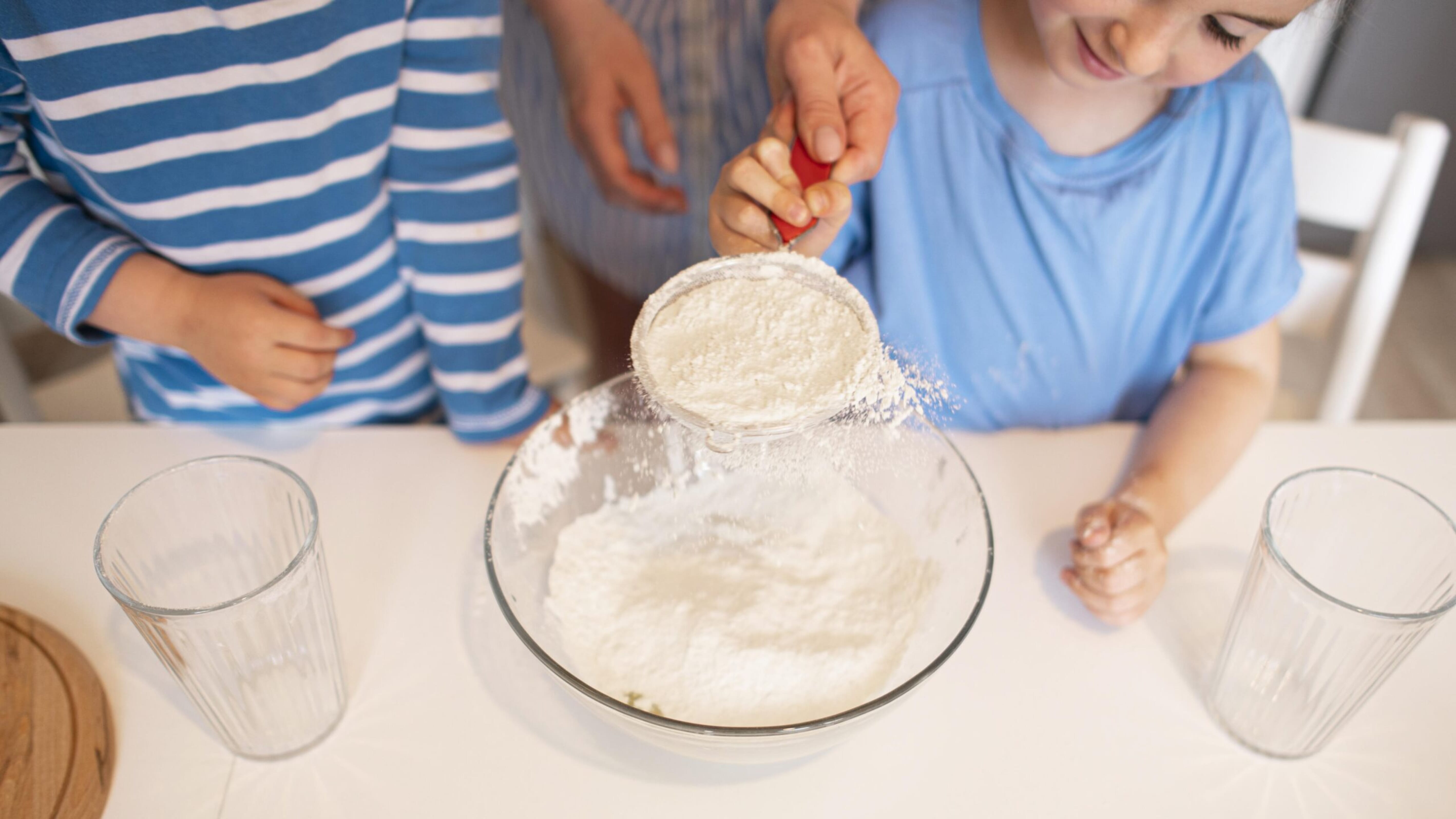 Child measuring ingredients at home
