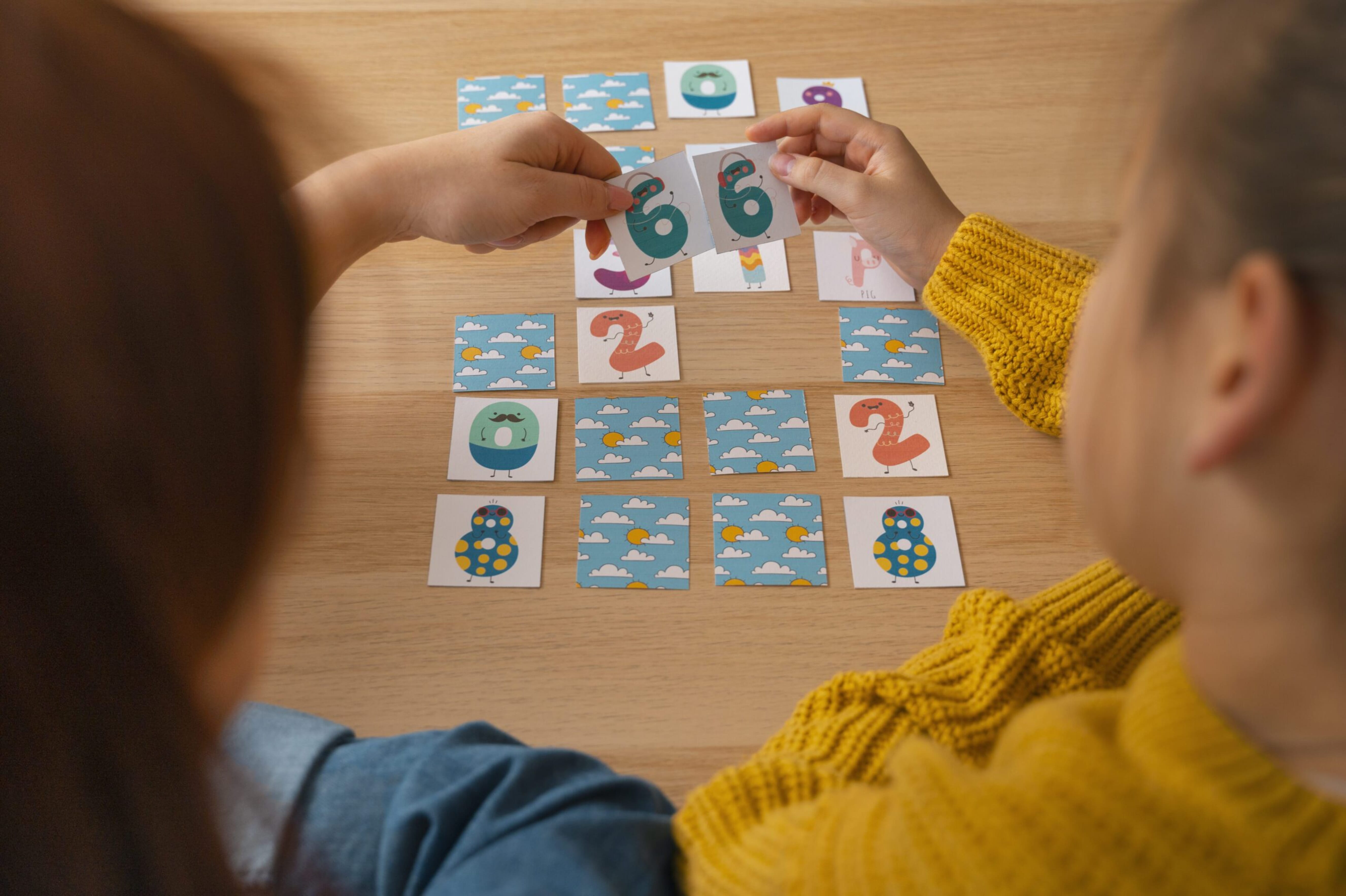 Child playing with learning cards memory game at nursery