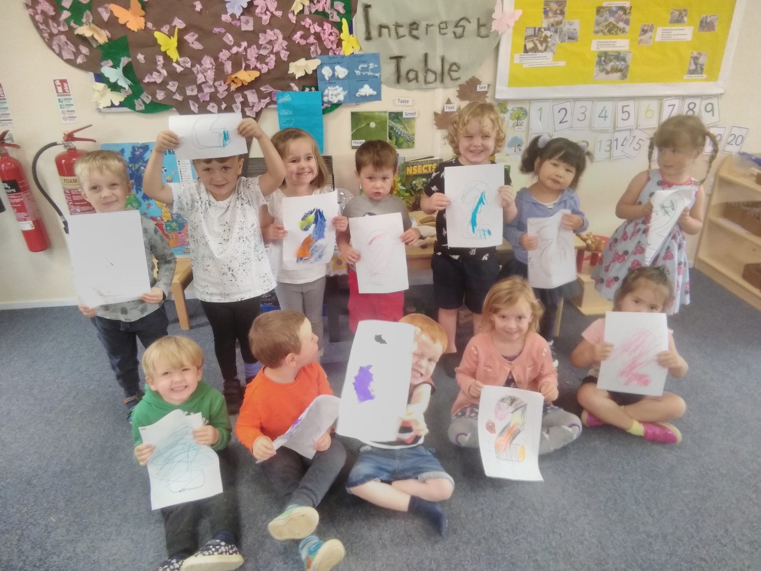 Children showing their drawings