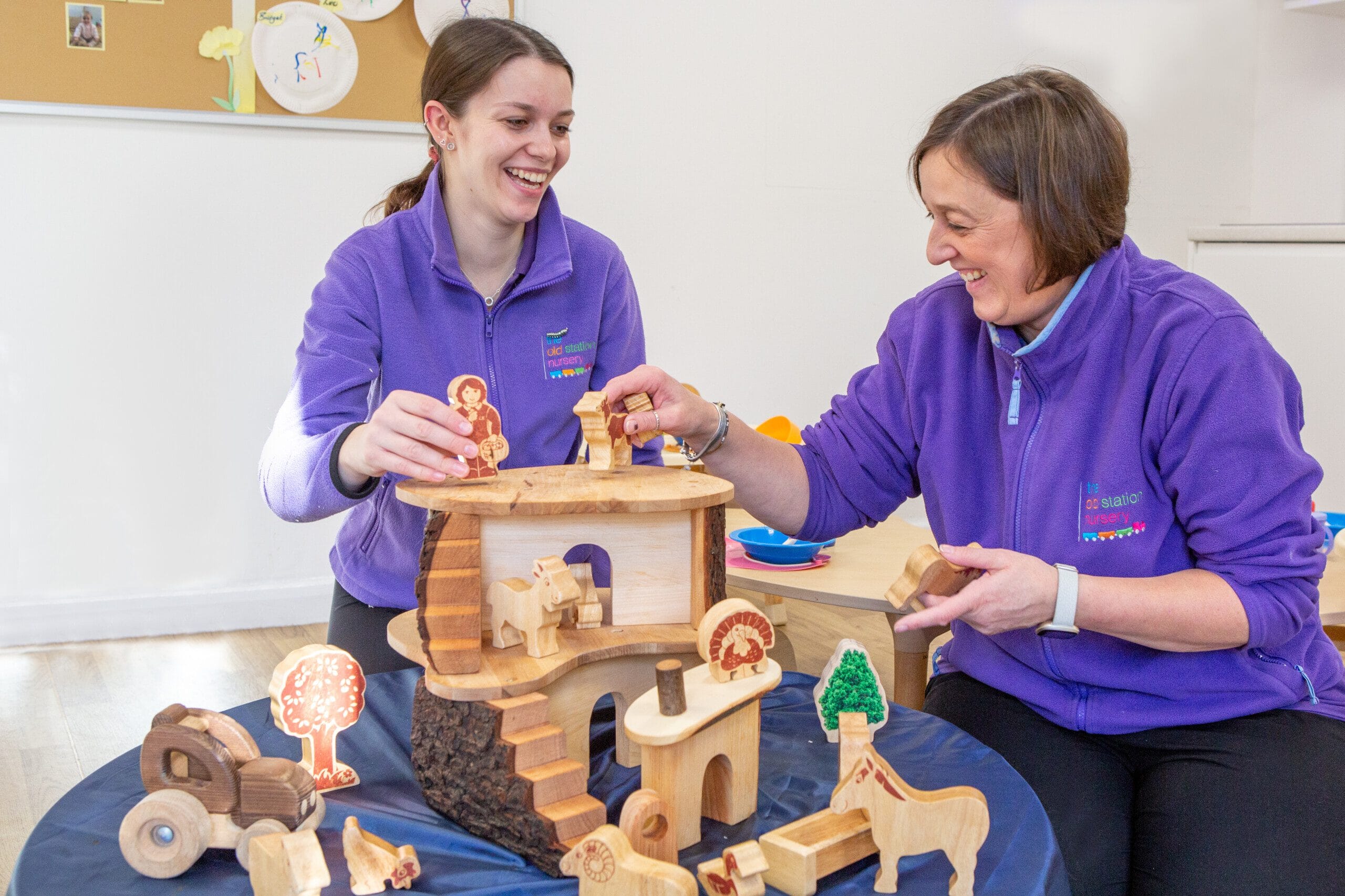 Nursery Practitioners/Apprentice setting up an activity at nursery