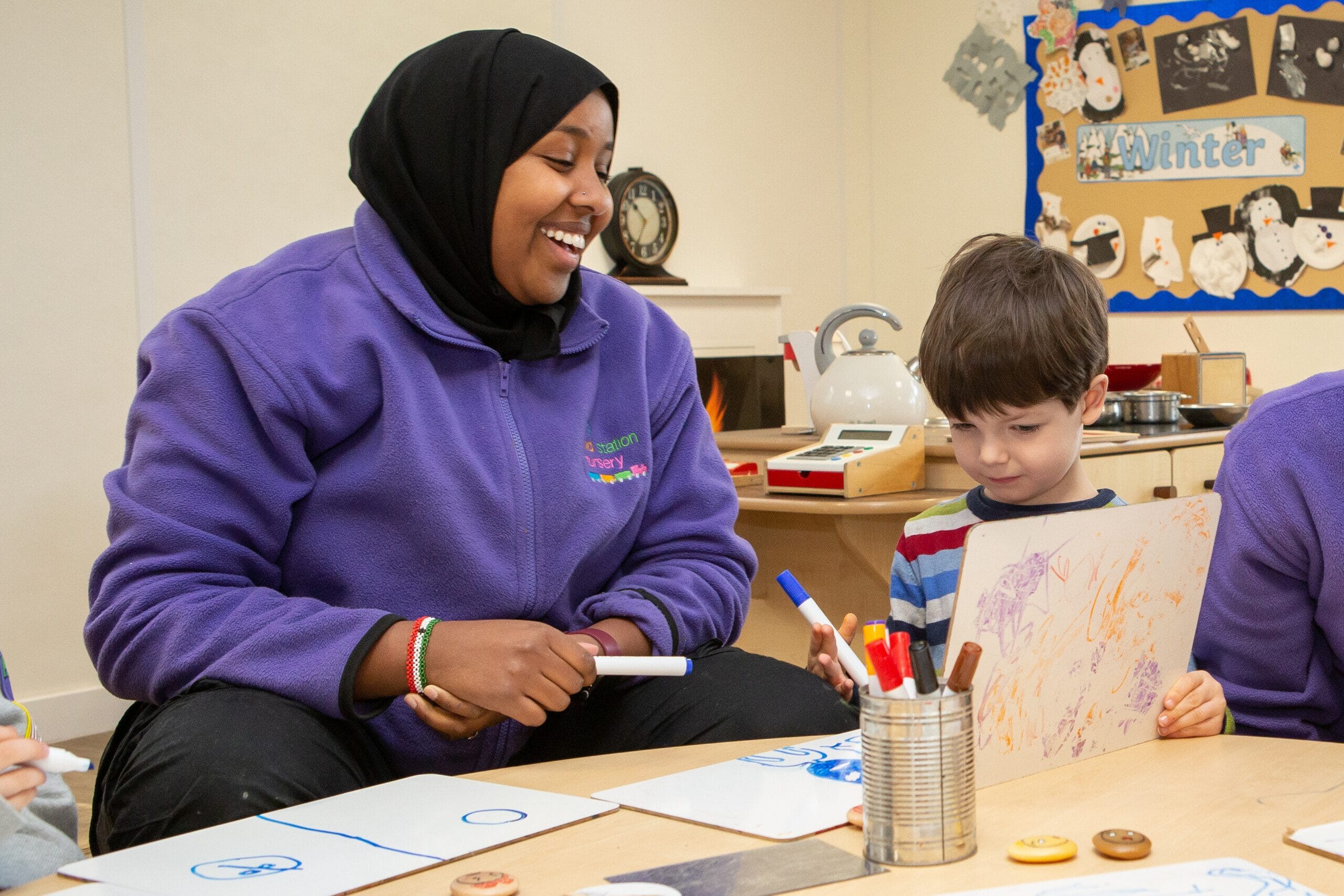 Nursery Practitioner with child taking part in an indoor activity