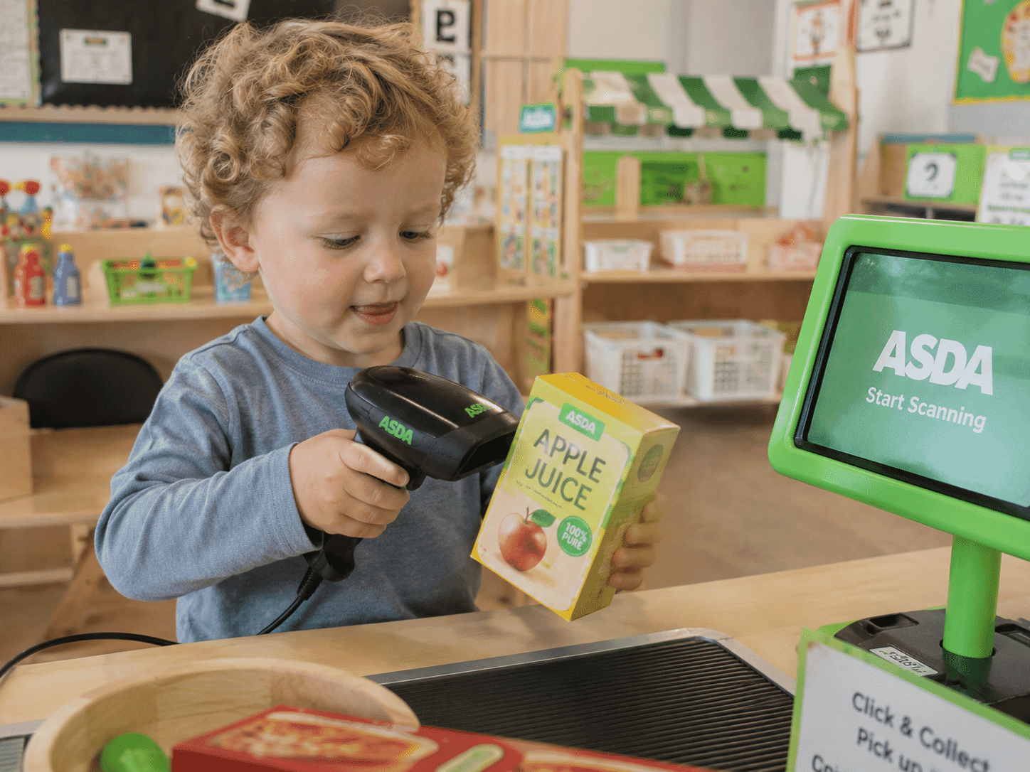 Child scanning items at nursery