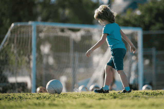 Young boy playing football